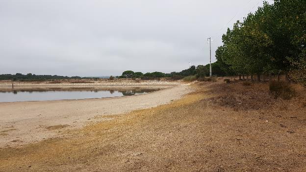 Road embankment acting as side of temporary storage reservoir for livestock (Portugal)