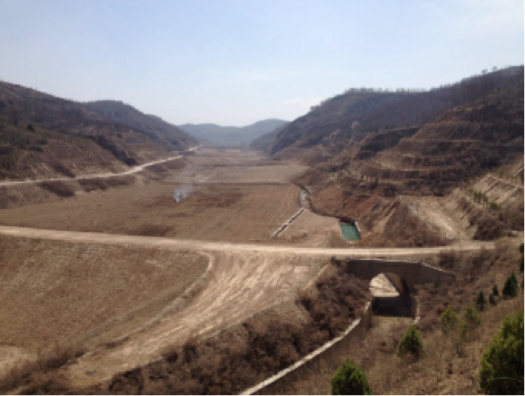 Road in combination with warping dam, making a degraded valley fertile with regularized drainage (Li 2016)